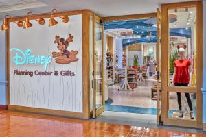 a store window with a sign for disney planning center and gifts at Walt Disney World Swan Reserve in Orlando