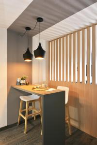una cocina con una mesa con 2 sillas y 2 luces en Moderno apartamento en Punta Carretas, en Montevideo