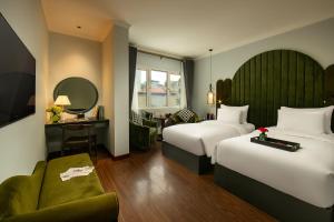 a hotel room with two beds and a couch at La Mejor Hotel & Sky Bar in Hanoi +101 photos