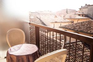 a balcony with chairs and a table and a view at Hotel San Luca in Verona