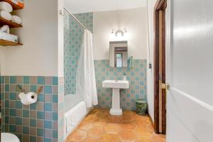 a bathroom with a sink and a shower at Pasters Apartment in Deconsecrated Church in New Orleans