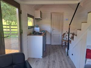 a small kitchen in a tiny house with a sink at Tiny House Waldschmied 1 in Latzendorf