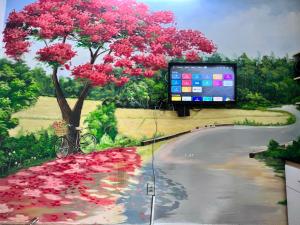 a painting of a tree with pink flowers on a road at Phoenix Flower Room R202-Central Saigon-near Ben Thanh in Ho Chi Minh City