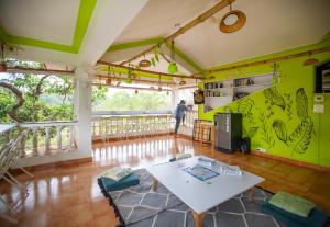 a living room with a white table and chairs at NomadGao Vila Nova - Social Hotel with Coworking, Fast WiFi, and Goan Charm in Anjuna