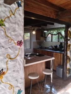 a kitchen with a counter and stools in a room at el diamante: Magic night in Santa Elena
