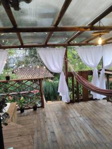 a porch with a hammock on a wooden deck at el diamante: Magic night in Santa Elena