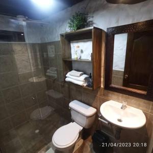 a bathroom with a toilet and a sink and a shower at el diamante: Magic night in Santa Elena