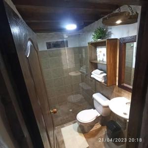 a bathroom with a toilet and a sink and a shower at el diamante: Magic night in Santa Elena