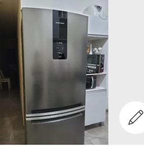 a stainless steel refrigerator in a kitchen at Casa para locação in Atibaia
