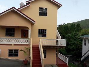 a house with a balcony and stairs at Caribbean Dream Vacation Property CD2 in Rodney Bay Village