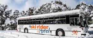 a snow covered bus is parked in the snow at Ski Rider Hotel in Kalkite