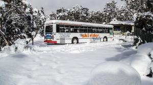 a bus driving down a snow covered street at Ski Rider Hotel in Kalkite
