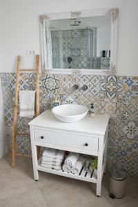 a bathroom with a white sink and a mirror at Villa Carla - Istrian house in Koper