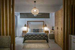 アギア・ペラギアにあるIrida Hotel Agia Pelagiaのベッドルーム(ベッド1台、ペンダントライト付)