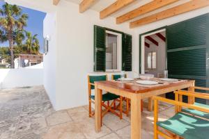 a dining room with a wooden table and chairs at Son Xoriguer 5 in Son Xoriguer