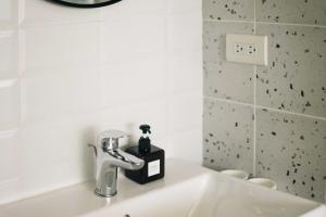 a bathroom sink with a soap dispenser on it at 無處 Nowhere Retreat 獨棟空間 in Yilan City