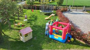 a childs playground with a toy train on the grass at RB Bed & Breakfast in Gaiba