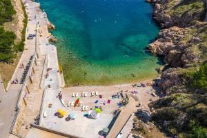 an aerial view of a beach with people in the water at Kristina in Vrbnik +9 photos