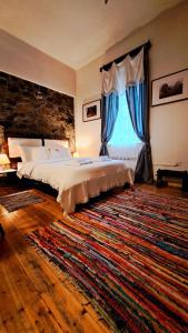 a bedroom with a large bed and a large rug at Vasiliki Guest House in Pedoulas