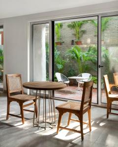 a dining room with a table and chairs at Bungalow 157 in New Delhi