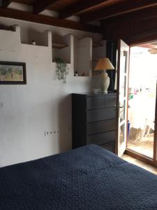 a bedroom with a bed and a table with a lamp at Casa Danesa - cityhouse at the palm tree, Puerto de Mogan in Puerto de Mogán