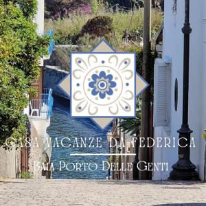 a sign with a blue and white star on a street at DA FEDERICA Casa Vacanze BAIA PORTO DELLE GENTI in Lipari