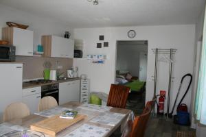 a kitchen with a table and a dining room at Liebevolle Fewo im Bayerischen Wald in Witzmannsberg