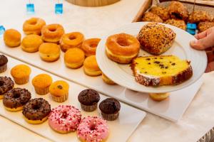 eine Platte mit verschiedenen Arten von Donuts auf einem Regal in der Unterkunft Hotel Raffaello in Bellaria-Igea Marina