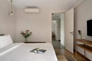 a bedroom with a bed with two books on it at Bungalow 157 in New Delhi
