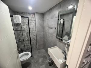 a bathroom with a toilet and a sink at Karaca Suite in Tuzla