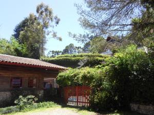 a house with a red fence in front of it at Sonja's Almhutte in Campos do Jordão