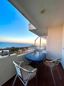 a blue table and chairs on a balcony with the ocean at Adriatic Apartments in Ulcinj