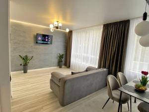 a living room with a couch and a table at Пан Апарт #1 in Truskavets