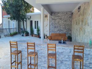 a group of four chairs sitting in front of a building at Holiday Home Mico in Drvenik +31 photos