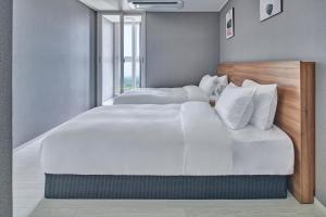 Gangneung Chonpines Ocean Suites Hotel客房内的一张或多张床位