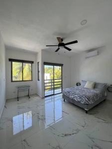 una camera da letto con un letto e un ventilatore a soffitto di Luxurious Ocean View Villa a Cozumel Altre 11 foto