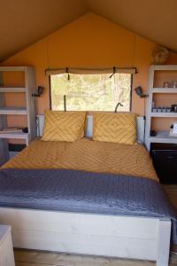 a bed in the middle of a tent at Safaritent Lodge 2 plus in Ruurlo