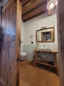 W łazience znajduje się umywalka i lustro. w obiekcie Agriturismo Montefabbrello w mieście Magazzini