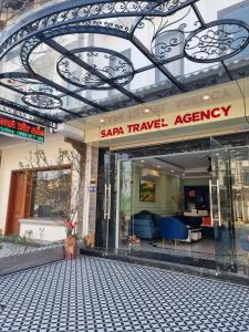 a saar trance agency building with a sign on it at Sapa Tay Bac Home in Sa Pa