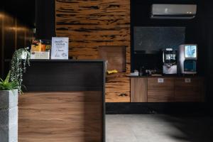 a coffee shop with a counter and a wooden wall at Xiang Zhai Jiao C in Jiaoxi