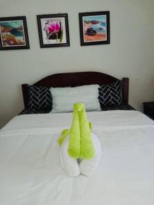 a stuffed animal sitting on top of a bed at Amani Grand Residence near Mactan Cebu Intl Airport in Mactan