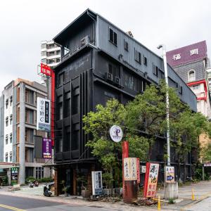 a black building on the side of a street at Xiang Zhai Jiao C in Jiaoxi
