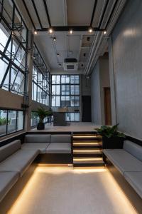 an office with couches and a staircase in a room at EX2 Hotel in Ban Bang Khen (1)