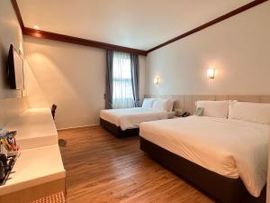 a hotel room with two beds and a window at Park View Hotel in Singapore