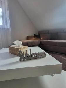 a living room with a couch and a coffee table at Flower Apartman 5 