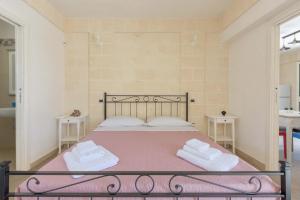 a bedroom with a bed with two towels on it at Villa Tina Maria by BarbarHouse in San Pietro in Bevagna