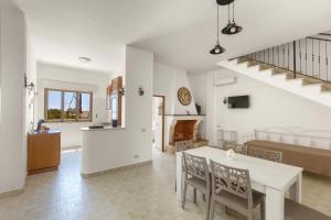 a kitchen and living room with a table and chairs at Villa Tina Maria by BarbarHouse in San Pietro in Bevagna