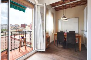 a room with a balcony with a table and a view at Apartment Arquímedes in Barcelona