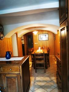 a kitchen and dining room with a table and chairs at La Quiete nel verde in Boves