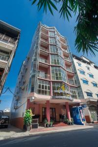 a tall building on the side of a street at Silver Mounts Hotel in Phnom Penh